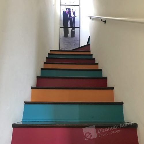 Colorful stairs add whimsey to this colorful interior design project.